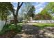 Scenic backyard view with lush greenery, a paved pathway, and a charming patio, offering a peaceful outdoor escape at 2909 Park Rd, Charlotte, NC 28209