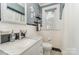 Updated bathroom with black and white tile, marble countertop, and a window with natural light at 2909 Park Rd, Charlotte, NC 28209