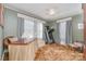 Light-filled bedroom with a green walls, ceiling fan, desk and a carpet with a pattern at 2909 Park Rd, Charlotte, NC 28209