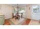 Dining area showcasing hardwood floors, bright windows and back yard views at 2909 Park Rd, Charlotte, NC 28209