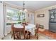 Bright dining room with natural light, wooden floors, and view of backyard at 2909 Park Rd, Charlotte, NC 28209