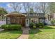Charming home exterior with a screened-in porch, well-maintained lawn, and a brick pathway at 2909 Park Rd, Charlotte, NC 28209