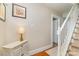 Entry way featuring hardwood floors, a staircase, and a decorative cabinet with a lamp at 2909 Park Rd, Charlotte, NC 28209