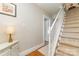 Entry way featuring hardwood floors, a staircase, and a decorative cabinet with a lamp at 2909 Park Rd, Charlotte, NC 28209