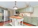 Well-designed kitchen with stainless steel appliances, green cabinets, and a center island at 2909 Park Rd, Charlotte, NC 28209