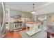 Open eat-in kitchen with green cabinets, stainless appliances, and center island at 2909 Park Rd, Charlotte, NC 28209