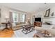 Bright living room boasts hardwood floors, neutral walls, and a cozy fireplace at 2909 Park Rd, Charlotte, NC 28209