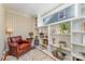 Cozy living room with built-in bookshelves, a leather chair, and a large window view at 2909 Park Rd, Charlotte, NC 28209