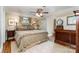 Comfortable bedroom with a ceiling fan, hardwood floors, and a charming decorative mirror at 2909 Park Rd, Charlotte, NC 28209
