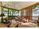 Relaxing covered porch with comfortable seating, wood accents and views of the backyard at 2909 Park Rd, Charlotte, NC 28209