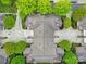 An aerial view displays a home with a detailed roof, surrounded by lush greenery and a concrete driveway at 2959 Bellasera Way, Matthews, NC 28105