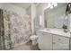 Cozy bathroom featuring vanity, tiled floor, and floral-patterned shower curtain for a relaxing space at 2959 Bellasera Way, Matthews, NC 28105