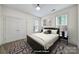 Stylishly staged bedroom with large bed, matching nightstands, and ample natural light from two windows at 2959 Bellasera Way, Matthews, NC 28105