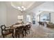Open-concept dining room and living room with carpet and fireplace at 2959 Bellasera Way, Matthews, NC 28105