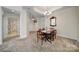 Open dining area with neutral carpet and a view of the bathroom at 2959 Bellasera Way, Matthews, NC 28105
