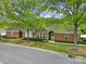 Exterior view of a well-maintained brick home with manicured landscaping and mature trees at 2959 Bellasera Way, Matthews, NC 28105