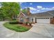 Charming stone and brick home with well-maintained landscaping and a two-car garage at 2959 Bellasera Way, Matthews, NC 28105