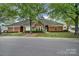 Front exterior view of a brick home with a well-manicured lawn and mature trees providing shade at 2959 Bellasera Way, Matthews, NC 28105