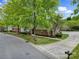 Exterior view of a well-maintained brick home with manicured landscaping, driveway, and mature trees at 2959 Bellasera Way, Matthews, NC 28105