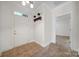 Inviting foyer with tile flooring, coat rack, and neutral paint at 2959 Bellasera Way, Matthews, NC 28105