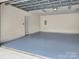 Spacious garage with painted floor, electrical panel, and door leading to outside at 2959 Bellasera Way, Matthews, NC 28105