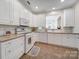 Bright kitchen features white cabinets and appliances at 2959 Bellasera Way, Matthews, NC 28105