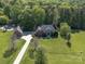 Overhead view of a large property with a pool, detached garage, long driveway, and lush trees at 3677 Antioch Church Rd, Matthews, NC 28104