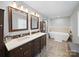 Modern bathroom featuring double vanity, soaking tub and patterned tile floor at 3677 Antioch Church Rd, Matthews, NC 28104