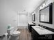 Modern bathroom with double vanity, tiled shower and tub combination at 3677 Antioch Church Rd, Matthews, NC 28104