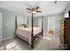 Bedroom showcasing a four-poster bed, neutral carpet, and ceiling fan at 3677 Antioch Church Rd, Matthews, NC 28104