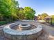 Outdoor fire pit surrounded by seating, landscaping, and a view of the pool area at 3677 Antioch Church Rd, Matthews, NC 28104