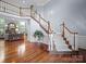 Grand foyer with hardwood floors, a sweeping staircase, and abundant natural light at 3677 Antioch Church Rd, Matthews, NC 28104