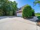 A paved driveway leads to a detached garage with a white door and brick facade at 3677 Antioch Church Rd, Matthews, NC 28104