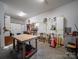 A garage converted into a workshop featuring tools, workbenches, and storage cabinets at 3677 Antioch Church Rd, Matthews, NC 28104