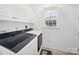 Clean laundry room with modern washer and dryer and built-in storage cabinets at 3677 Antioch Church Rd, Matthews, NC 28104