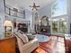 Bright living room featuring a stone fireplace, hardwood floors, and large windows at 3677 Antioch Church Rd, Matthews, NC 28104