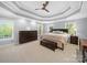 Serene main bedroom featuring a tray ceiling, soft lighting, and large windows for a relaxing ambiance at 3677 Antioch Church Rd, Matthews, NC 28104