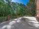 Spacious patio with outdoor dining area, fire pit, and private wooded views at 3677 Antioch Church Rd, Matthews, NC 28104
