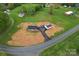 Aerial view shows a charming home and detached garage on an expansive lot, ready for new landscaping at 391 Springs East Rd, Lincolnton, NC 28092