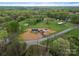 An aerial view showcases a newly constructed home and detached garage on a tree-lined lot, highlighting its serene setting at 391 Springs East Rd, Lincolnton, NC 28092