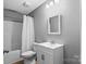 Clean bathroom featuring a white vanity, toilet, mirror, and shower with curtain at 391 Springs East Rd, Lincolnton, NC 28092