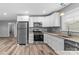 Modern kitchen with stainless steel appliances, white cabinets, and granite countertops at 391 Springs East Rd, Lincolnton, NC 28092