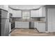 Modern kitchen with white cabinets, stainless steel appliances, granite countertops, and wood floors at 391 Springs East Rd, Lincolnton, NC 28092