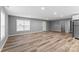 Spacious living area with modern wood flooring, neutral gray walls, and plenty of natural light at 391 Springs East Rd, Lincolnton, NC 28092