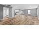 Open-concept living area with modern wood flooring and neutral gray walls extending into the kitchen at 391 Springs East Rd, Lincolnton, NC 28092