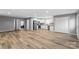 Open-concept living area with modern wood flooring, neutral gray walls, and stainless steel appliances at 391 Springs East Rd, Lincolnton, NC 28092