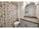 Charming bathroom featuring a granite countertop, neutral colored vanity, and an arched mirror with gold trim at 4032 Wild Turkey Ln, Indian Land, SC 29707