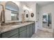 Beautiful bathroom features a dual sink vanity with a granite countertop, arched mirrors, and gold fixtures at 4032 Wild Turkey Ln, Indian Land, SC 29707