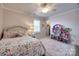 Bedroom featuring a ceiling fan, floral bedding, a window with blinds, a doll house, and a dresser at 4032 Wild Turkey Ln, Indian Land, SC 29707