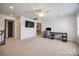 Bright bonus room features neutral carpet, a ceiling fan, and a sleek built-in desk with shelving at 4032 Wild Turkey Ln, Indian Land, SC 29707